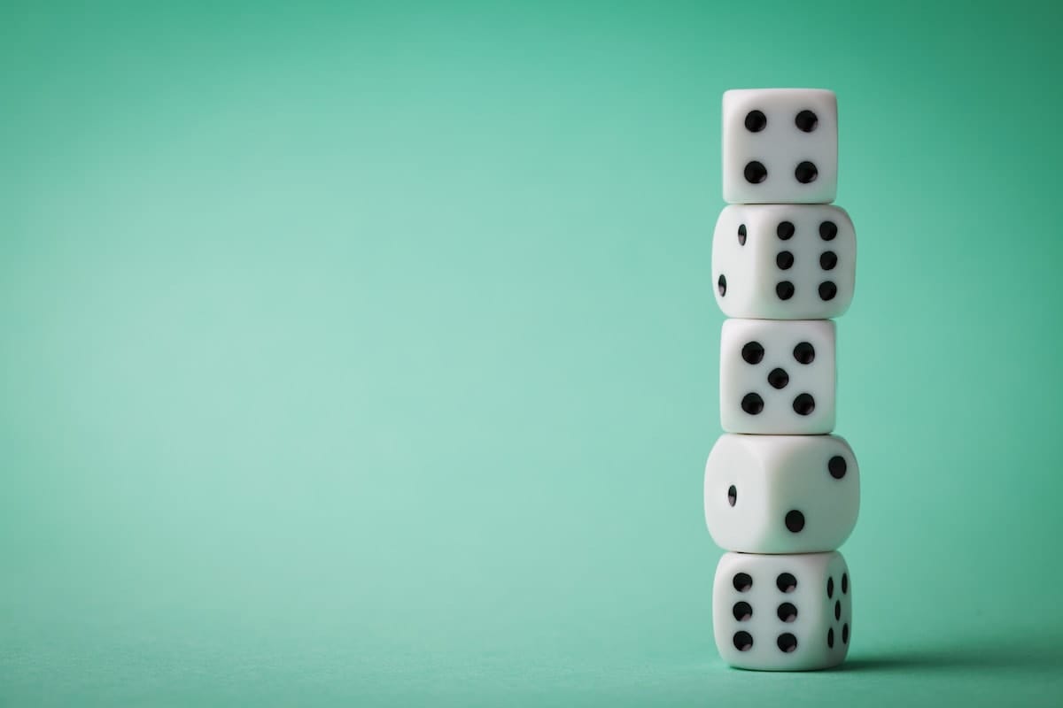 Photo of dice on bright green background.