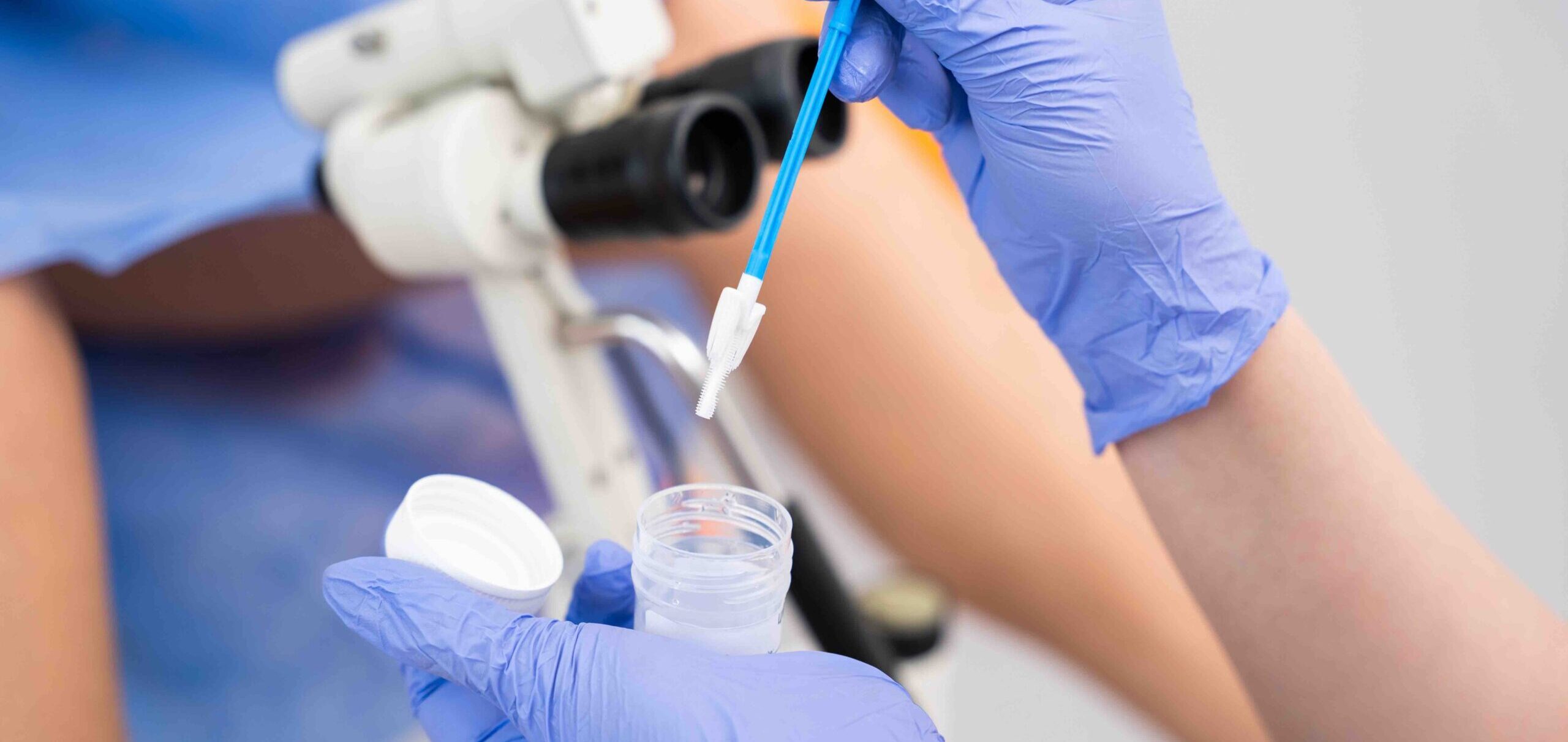 Close-up of a medical professional using a pipette and sample container during an STD test.